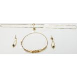 A suite of 9ct gold jewellery set with sapphires comprising bangle, earrings and necklace, 10.2g