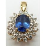 A 9ct gold pendant set with an oval cut kyanite surrounded by diamonds