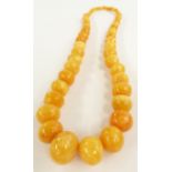A Baltic amber necklace made up of 57 graduated beads, 101g
