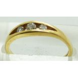 An 18ct gold ring set with three diamonds, 2.5g, size N