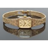 Omega 9ct gold ladies wristwatch with two tone hands and baton markers, gold dial and signed 17
