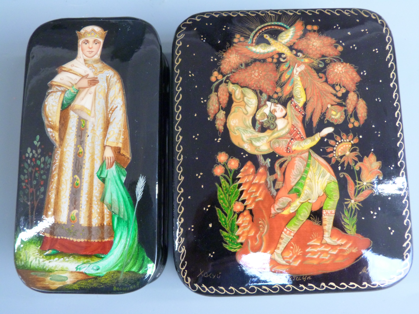 Two Russian lacquer boxes, one depicting a lady in traditional dress (approximately 5cm x 10cm x 2.