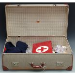 WWII era nurse's cape, hat, first aid box, vintage first aid and anatomy books all in a vintage