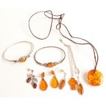 Two silver bangles set with pressed amber, two pairs of silver earrings set with pressed amber,