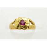 A gold child's ring set with a synthetic ruby