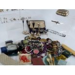 A collection of costume jewellery including beads, silver earrings, silver plate, silver locket,