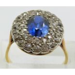 An 18ct gold ring set with a synthetic sapphire surrounded by old cut diamonds, 4.4g, size P/Q