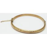 A 9ct gold bangle with cut out decoration, 6.1g