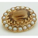 A 9ct gold brooch set with an oval cut citrine surrounded by seed pearls, 2.2 x 1.8cm