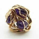 A 9ct gold ring set with three amethyst pebbles, size K, 12.4g