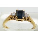 An 18ct gold ring set with a square cut sapphire and diamonds, 3.2g, size N