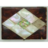 A mother of pearl and tortoiseshell card case, the front set with an etched white metal plaque.