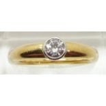 An 18ct gold ring set with a round cut diamond measuring approximately 0.3ct, 5.4g, size M
