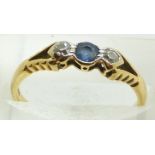 An 18ct gold ring set with a sapphire and two diamonds, 2g, size L