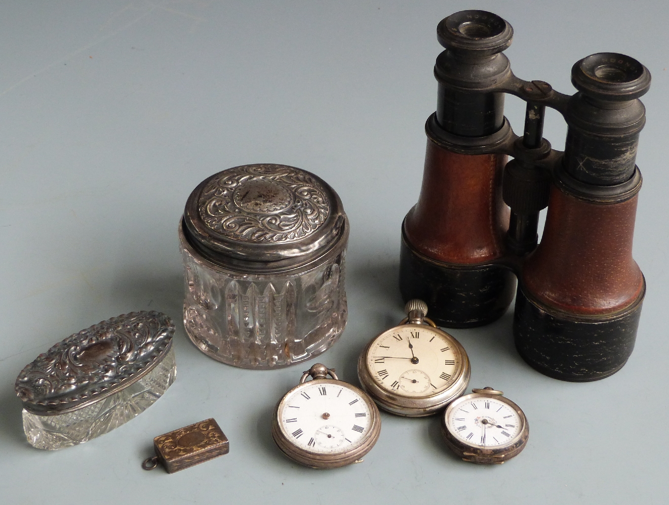 Two hallmarked silver topped dressing table pots, three pocket watches, two being white metal cased,