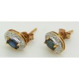 A pair of 9ct gold earrings set with sapphire and diamonds