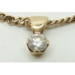 A 9ct gold pendant set with a diamond measuring approximately 0.5ct on a 9ct gold necklace, 8.6g