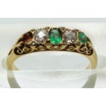 An 18ct gold ring set with diamonds and emeralds in original box, size K