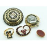 An inlaid Victorian brooch, a mourning brooch, and a Victorian brooch set with Bohemian rose cut
