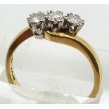 An 18ct gold ring set with three diamonds in a twist setting, each diamond approximately 0.2ct, 4.