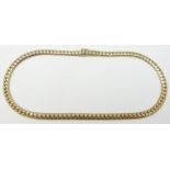 A 9ct gold necklace made up of flat curb links, 57g