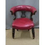 Oxblood red leather button back and carved mahogany library or captain's chair