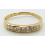 A yellow metal ring set with nine princess cut diamonds, 1.7g