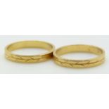 A pair of 18ct gold rings with foliate decoration, 4.7g, both size M