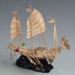 Chinese or similar Far Eastern novelty white metal model of a warship with sails, oars and figures