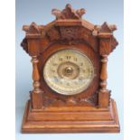 Oak cased mantel clock, the two train eight day movement by Ansonia, New York striking on a gong,