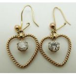 A pair of bespoke 9ct gold earrings each set with a diamond measuring approximately 0.4ct in a heart