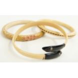 A 1920's Art Deco ivory flapper bangle with elephant hair to the centre, Art Deco snake flapper