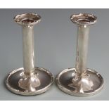 Pair of George V hallmarked silver candlesticks with castellated bases and tops, Birmingham 1928