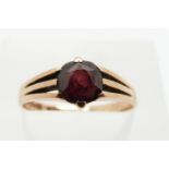 A 9ct gold ring set with a round cut garnet, 1.7g, size M