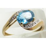 A 9ct gold ring set with a blue topaz and diamonds, 2.6g, size S
