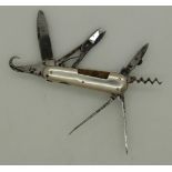 19thC miniature multi-tool penknife with 7 blades and white metal sides, approximate length 4.5cm