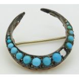 Victorian crescent brooch set with graduated turquoise cabochons and two diamonds, 3.1cm