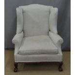 19thC wing back armchair raised on ball and claw feet