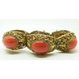 A silver gilt filigree bracelet set with coral cabochons