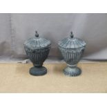 Two lidded cast iron urns, height 43cm, copper coal bucket and a brass trivet