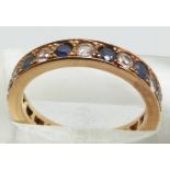 A 9ct gold eternity ring set with alternating sapphires and white sapphires, 4.1g, size N