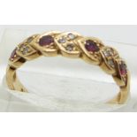 A 9ct gold ring set with garnets and diamonds, 2.2g, size O/P