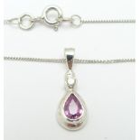 A 9ct white gold necklace set with a pear cut pink sapphire and a round cut diamond, 1.9g