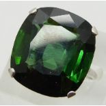 A platinum ring set with a large cushion cut tourmaline measuring approximately 22.6ct and