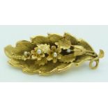 Victorian brooch/ pendant set with seed pearls in a textured floral and leaf design, 4.8g, 5 x 2cm