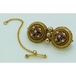 Victorian Etruscan Revival gold brooch set with foiled amethysts within applied rope twist