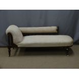 Victorian upholstered mahogany chaise longue with carved detail, raised turned legs and ceramic