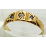 An 18ct gold ring set with an old cut diamond and two sapphires, Chester 1891, 2.6g, size M