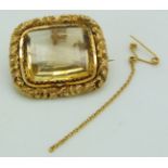 Victorian gold brooch set with a mixed cut citrine within a scrolling border, 10.5g, 3 x 2.6cm