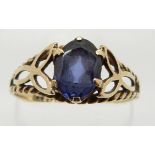 A 9ct gold ring set with an oval cut synthetic sapphire, 1.8g, size R